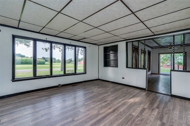 empty room featuring plenty of natural light and hardwood / wood-style floors