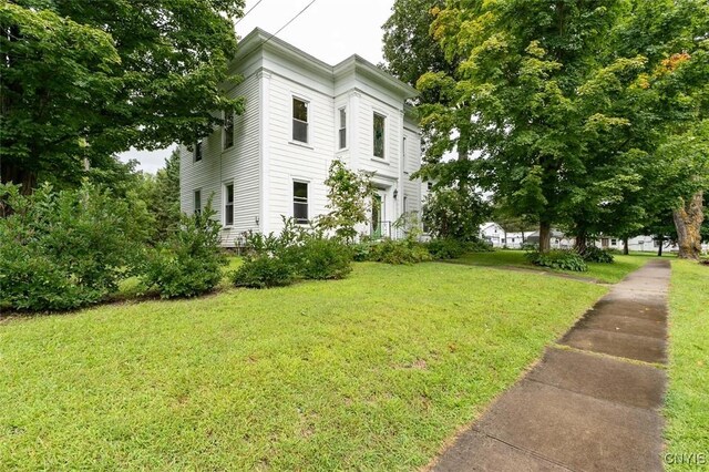 view of side of property with a lawn