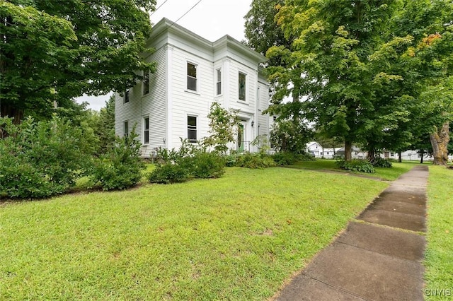 view of side of property with a yard