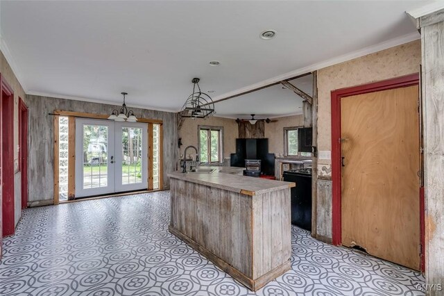 kitchen with sink, decorative light fixtures, plenty of natural light, and light tile patterned floors