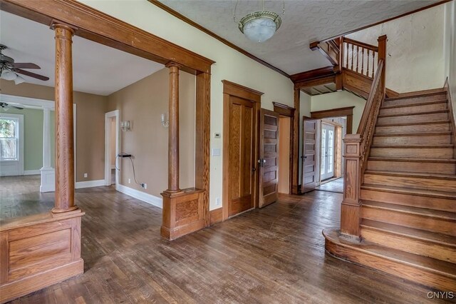 entryway featuring dark hardwood / wood-style flooring, a textured ceiling, decorative columns, and ceiling fan