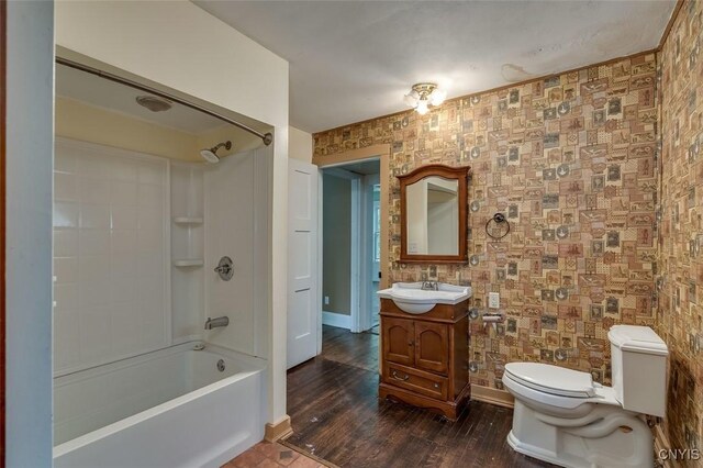 full bathroom featuring toilet, hardwood / wood-style floors, shower / washtub combination, and vanity