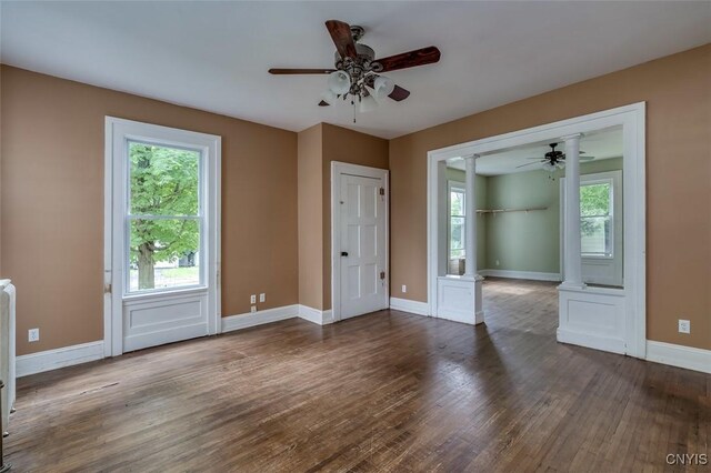 unfurnished room featuring hardwood / wood-style floors, plenty of natural light, and ceiling fan