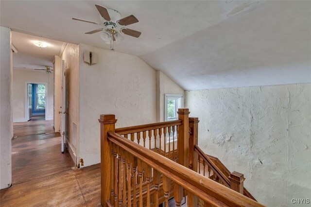 corridor featuring vaulted ceiling and hardwood / wood-style floors