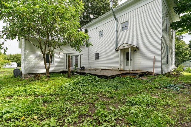 back of house with a wooden deck and french doors