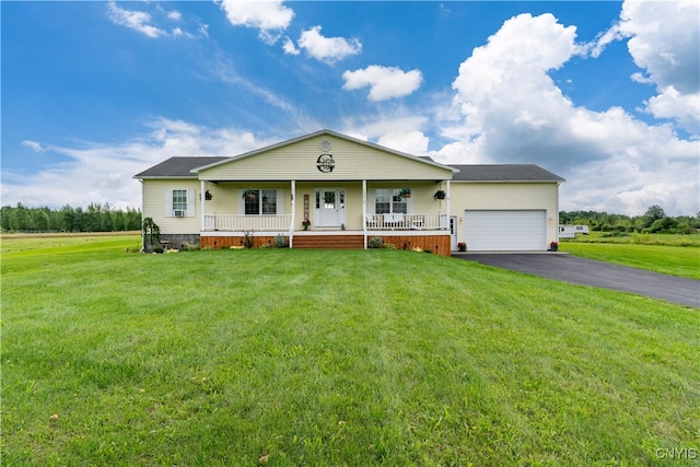 single story home featuring covered porch, a garage, and a front lawn