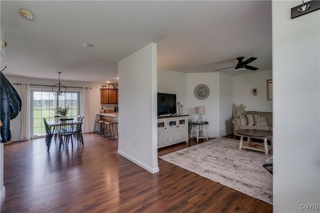 living room with ceiling fan and dark hardwood / wood-style floors