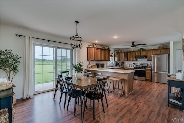 dining area featuring ceiling fan and dark wood-type flooring