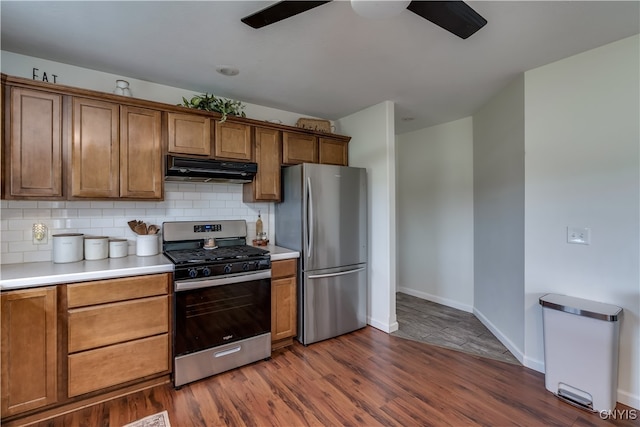 kitchen featuring extractor fan, appliances with stainless steel finishes, dark hardwood / wood-style floors, and ceiling fan