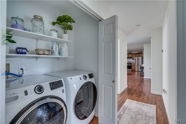 laundry room featuring washer and dryer and hardwood / wood-style floors