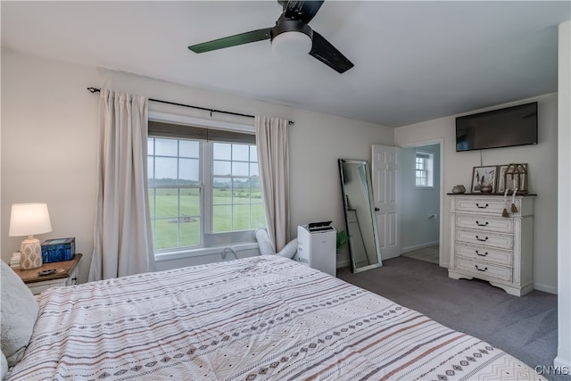 bedroom with ceiling fan and dark carpet