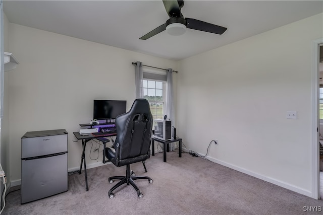 office space featuring ceiling fan and light carpet