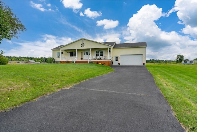 view of front of home with a front yard, a garage, and covered porch