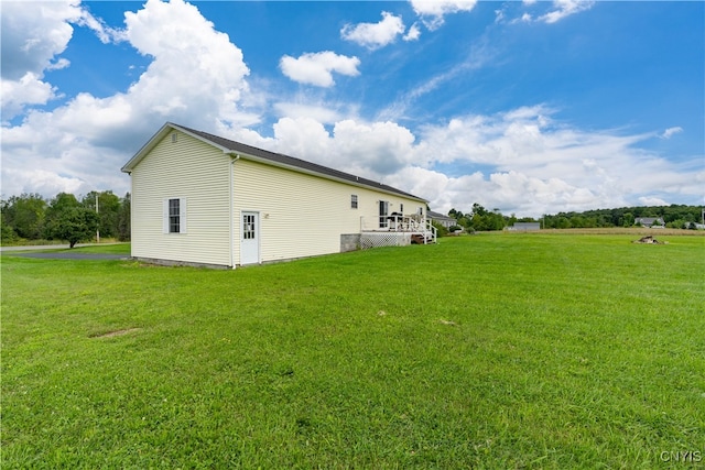 view of side of home with a lawn