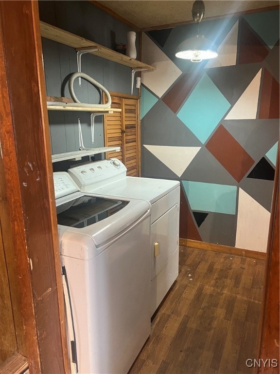 laundry room with dark hardwood / wood-style floors and washer and clothes dryer