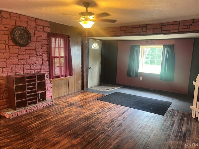 entryway featuring dark wood-type flooring, a textured ceiling, and ceiling fan