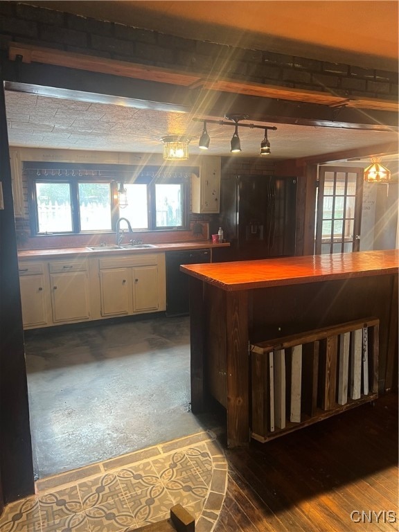 bar featuring a healthy amount of sunlight, white cabinetry, sink, and wood-type flooring