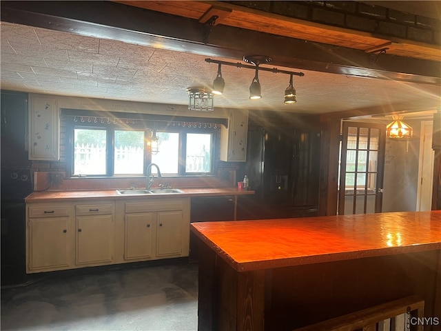 kitchen featuring dishwasher, decorative light fixtures, and sink