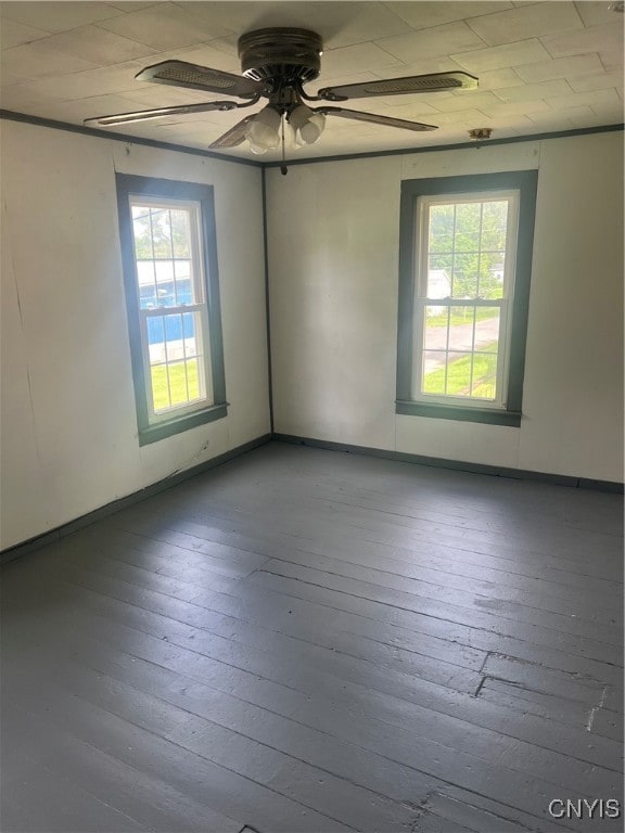 empty room featuring wood-type flooring and ceiling fan