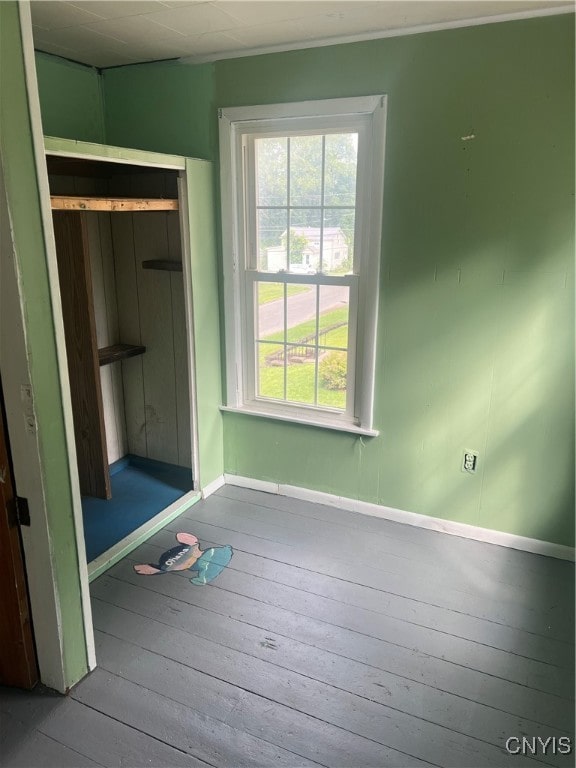 unfurnished bedroom featuring a closet and wood-type flooring