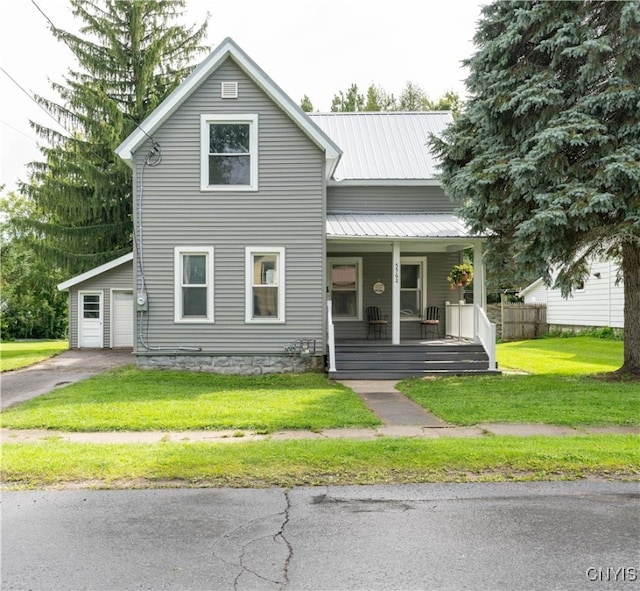 view of front of property with a front yard, a garage, and covered porch