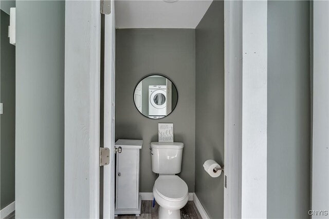 bathroom with hardwood / wood-style flooring and toilet