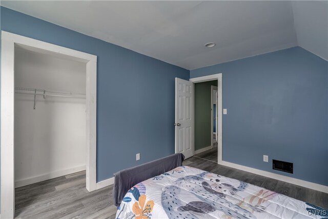 bedroom with hardwood / wood-style flooring and a closet