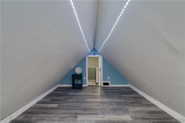 additional living space featuring lofted ceiling and hardwood / wood-style floors