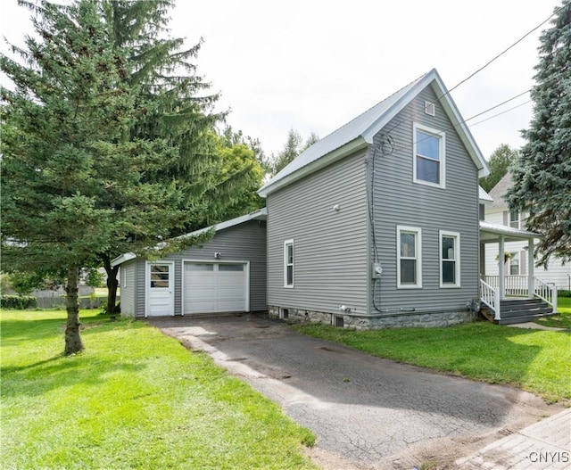 view of side of home featuring a lawn and a garage