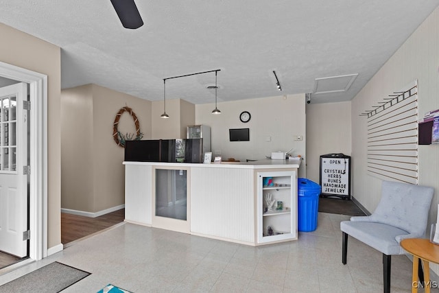 kitchen with ceiling fan, hardwood / wood-style flooring, a textured ceiling, and rail lighting