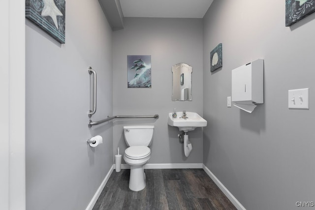 bathroom with sink, toilet, and wood-type flooring