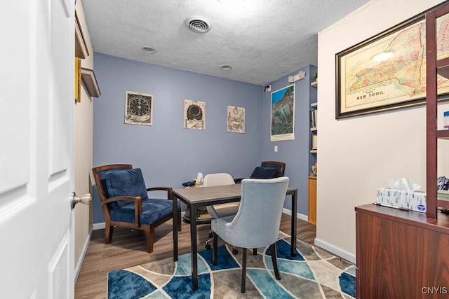 interior space featuring light hardwood / wood-style flooring and a textured ceiling