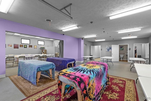 554 S 1st St, Fulton, NY 13069 - dining space with finished concrete floors and a textured ceiling