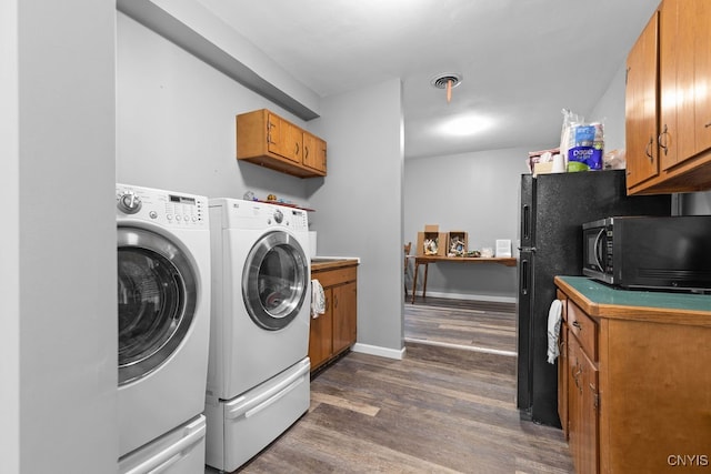 washroom featuring separate washer and dryer and dark hardwood / wood-style flooring