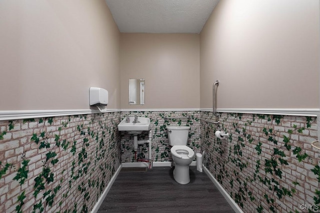 554 S 1st St, Fulton, NY 13069 - bathroom featuring wainscoting and wood finished floors