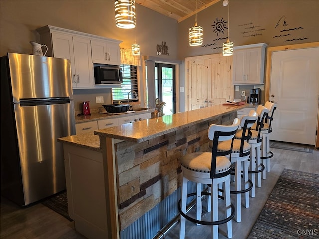 kitchen featuring wooden ceiling, stainless steel appliances, dark hardwood / wood-style flooring, and hanging light fixtures