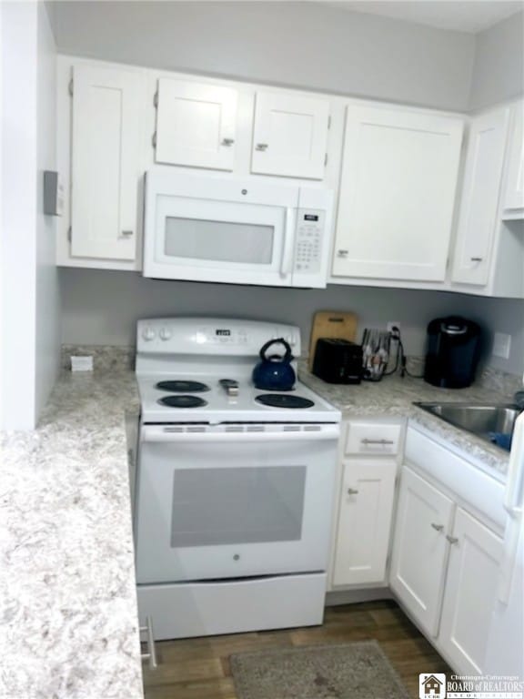 kitchen featuring sink, dark wood-type flooring, white appliances, and white cabinets