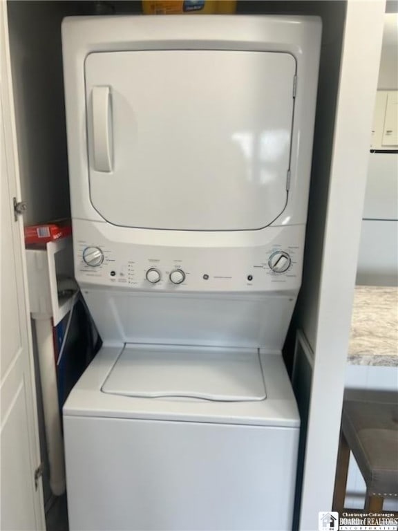 laundry area featuring stacked washer / dryer