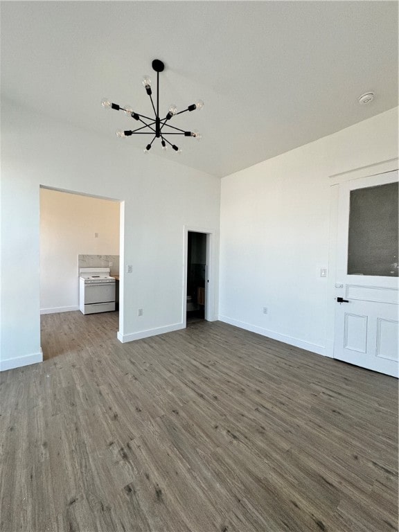 unfurnished living room featuring hardwood / wood-style flooring and a chandelier