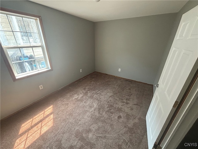 carpeted empty room with a wealth of natural light