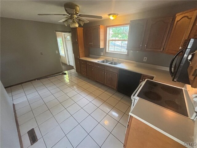 kitchen featuring light tile patterned flooring, sink, dishwasher, ceiling fan, and stove