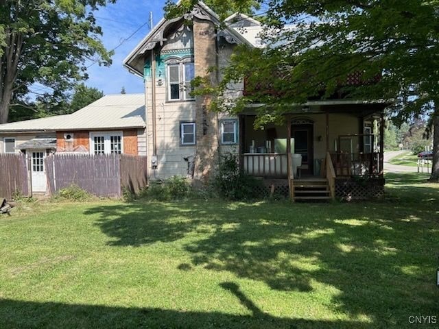 rear view of house with a yard