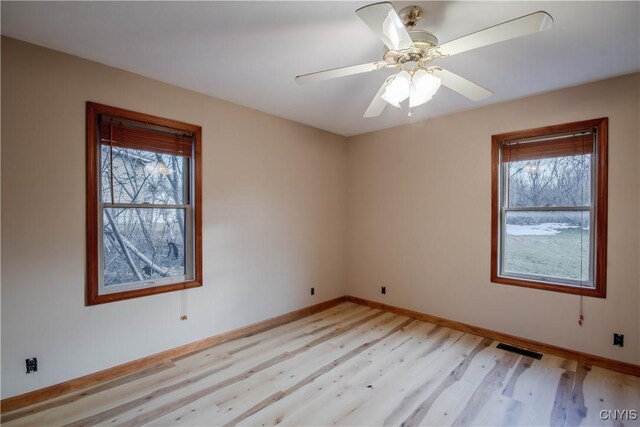 empty room featuring ceiling fan and light hardwood / wood-style flooring