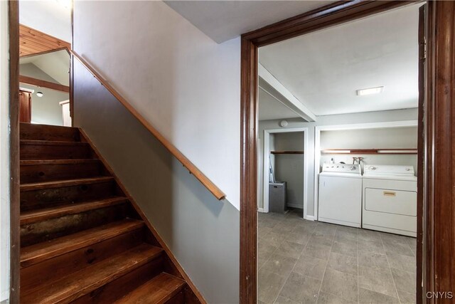 stairway featuring tile patterned flooring and washing machine and dryer