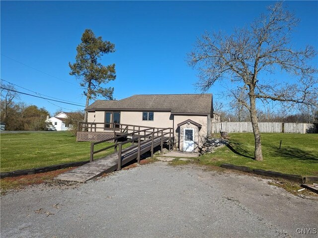 view of front of home with a front lawn and a deck