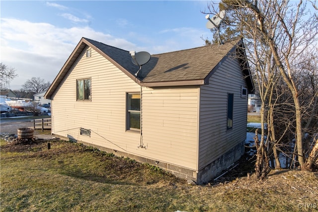 view of property exterior with a lawn