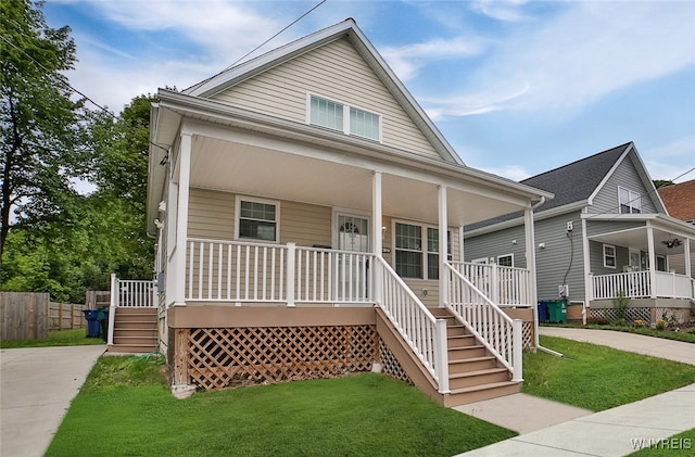 view of front of home featuring a front lawn and covered porch