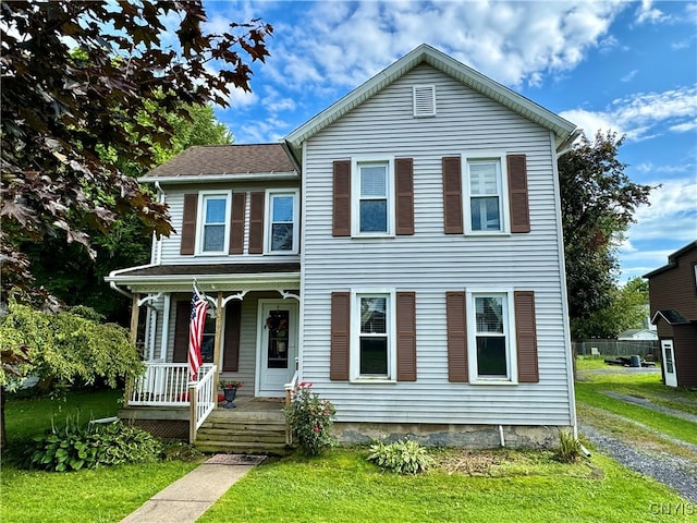 view of front of property with a front yard and a porch