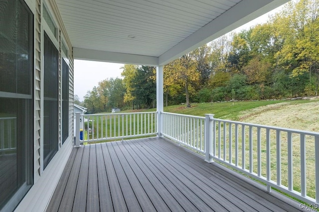 wooden deck with a lawn