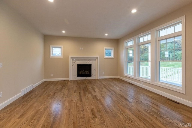 unfurnished living room with a fireplace and hardwood / wood-style flooring